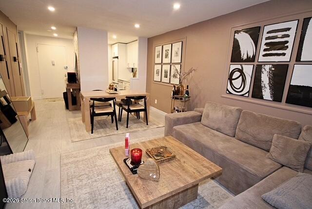 1000 Clove Road, Unit 2P Staten Island, NY 10301 - Photo 11 of 22 a living room with furniture a rug and white walls