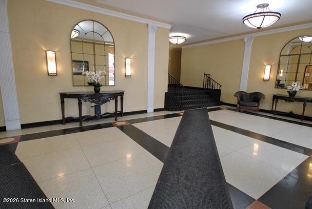 1000 Clove Road, Unit 2P Staten Island, NY 10301 - Photo 20 of 22 a living room with couches dresser and a large mirror next to a window