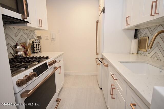 1000 Clove Road, Unit 2P Staten Island, NY 10301 - Photo 10 of 22 a kitchen with a stove and a sink