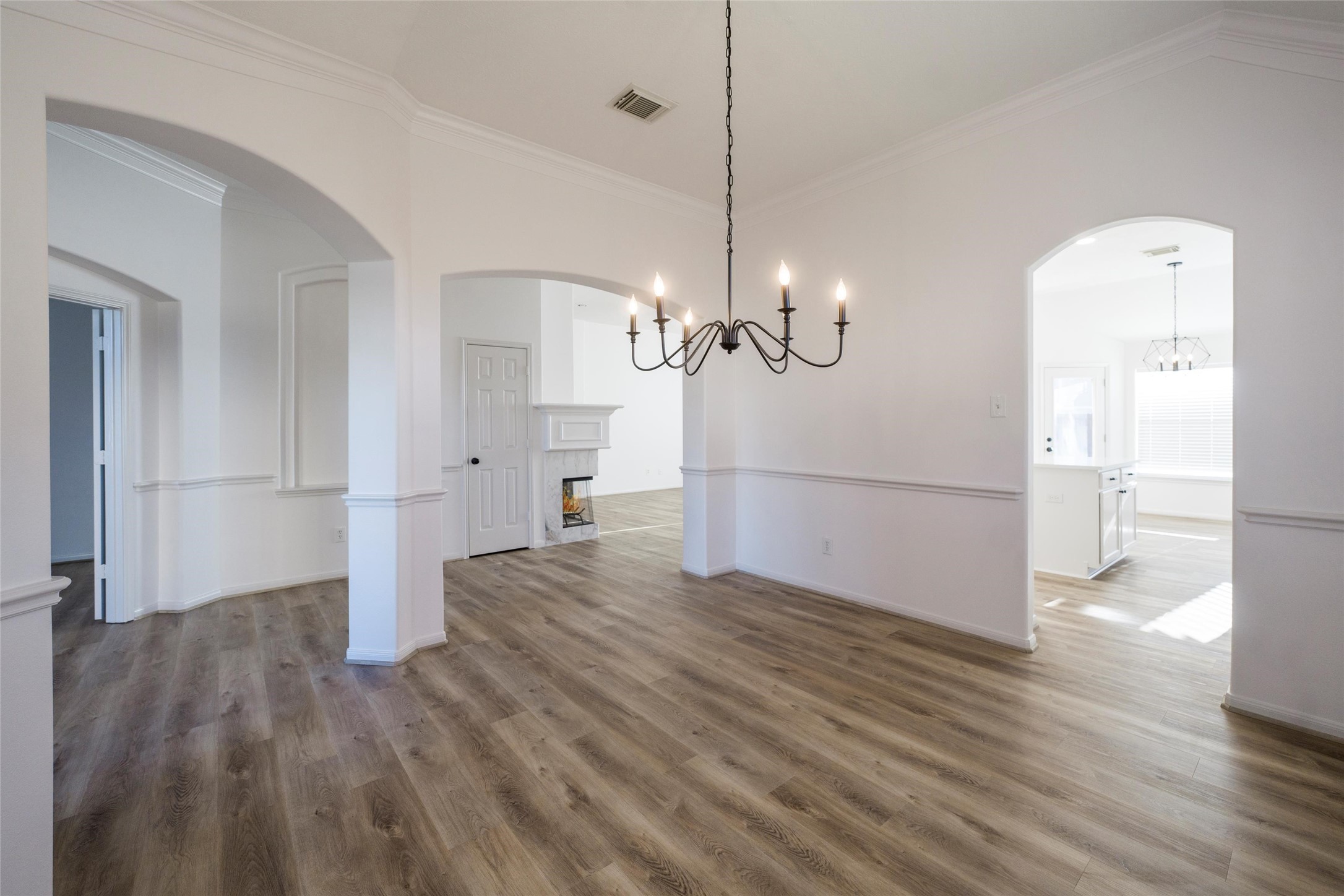 3303 Viking Landing Court Spring, TX 77388 - Photo 11 of 46 a view of a room with wooden floor staircase and a kitchen space
