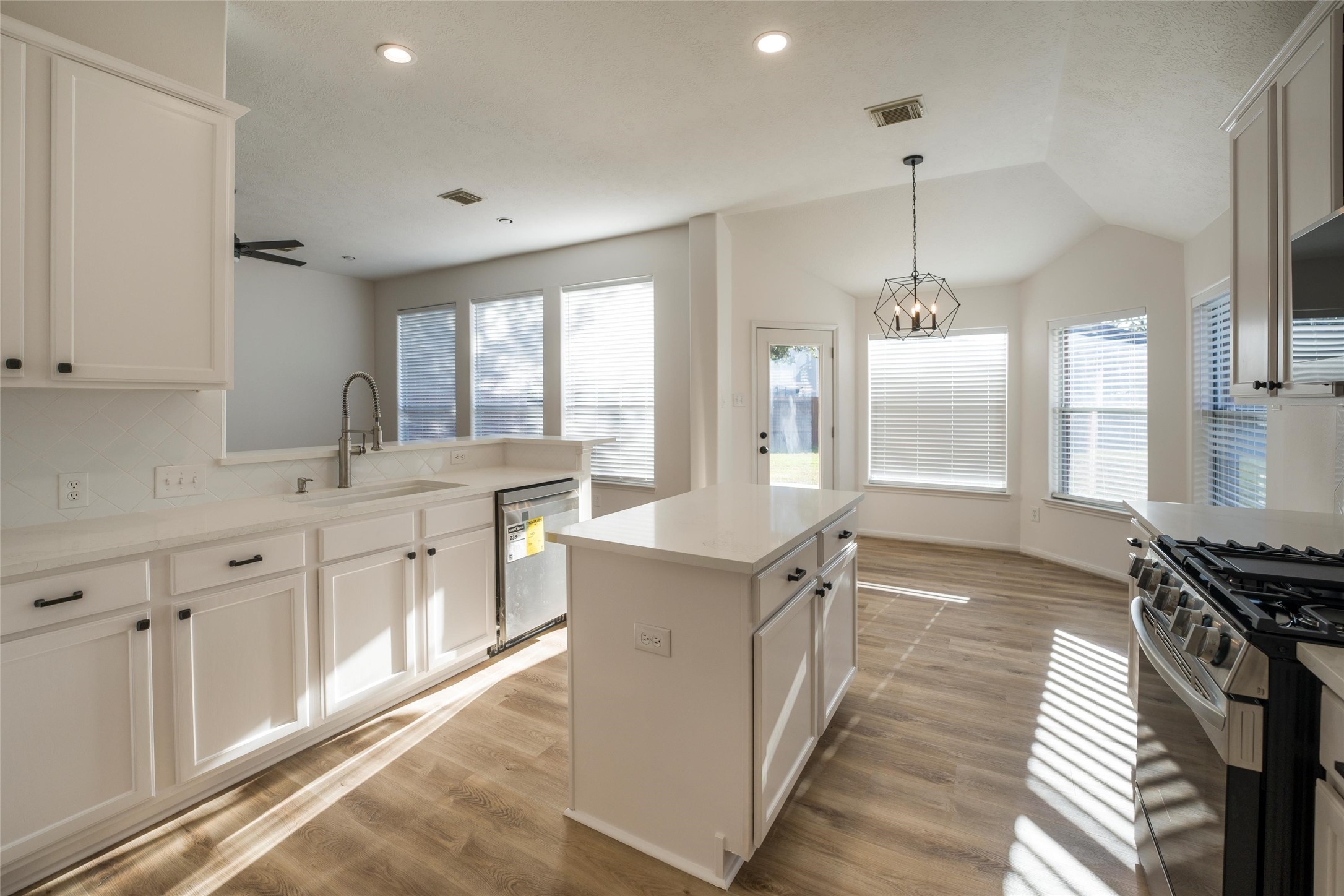 3303 Viking Landing Court Spring, TX 77388 - Photo 12 of 46 a kitchen with stainless steel appliances granite countertop a sink stove and refrigerator