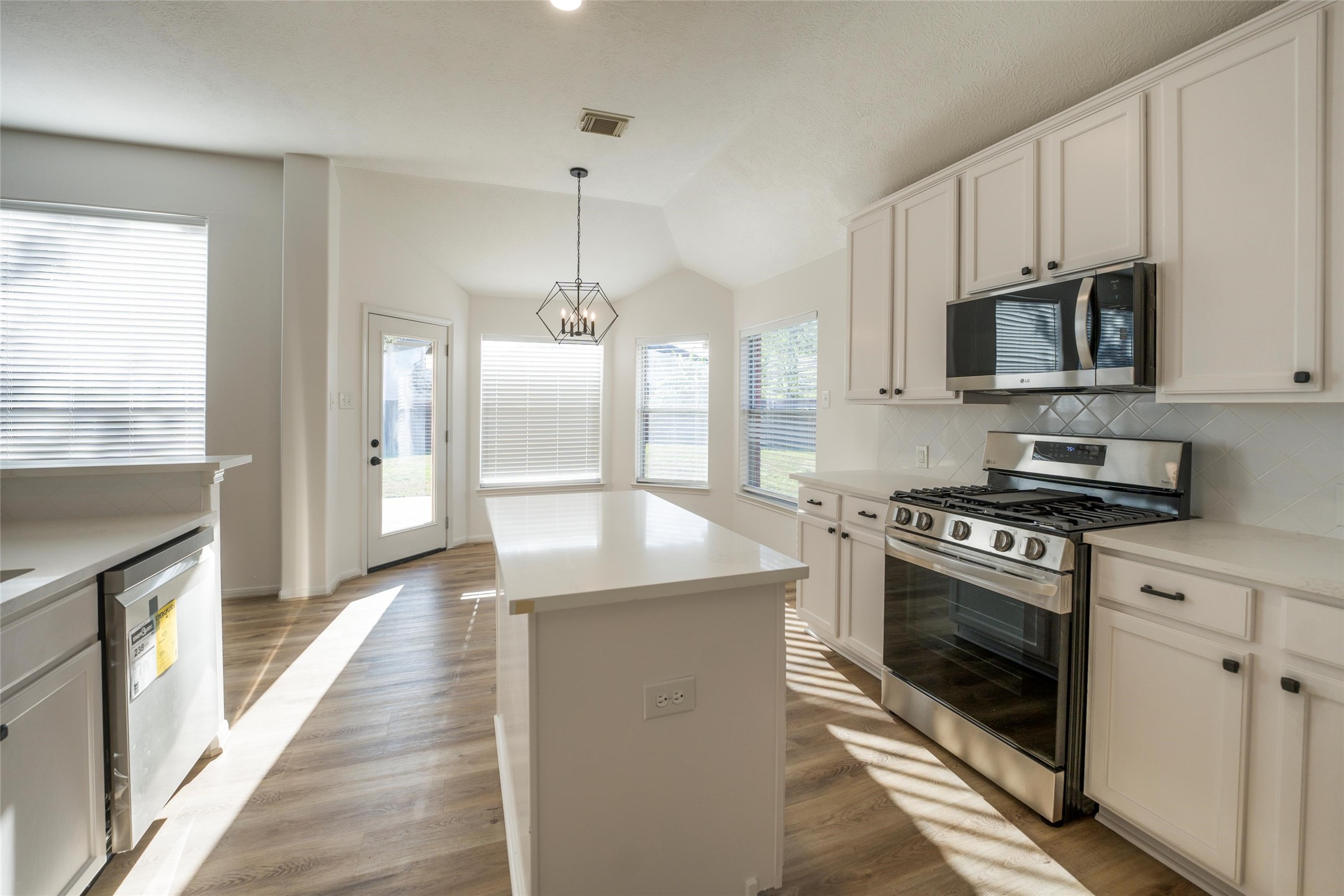 3303 Viking Landing Court Spring, TX 77388 - Photo 13 of 46 a kitchen with stainless steel appliances granite countertop a stove a sink and a refrigerator