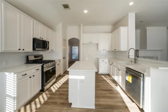 a kitchen with a sink stove and refrigerator