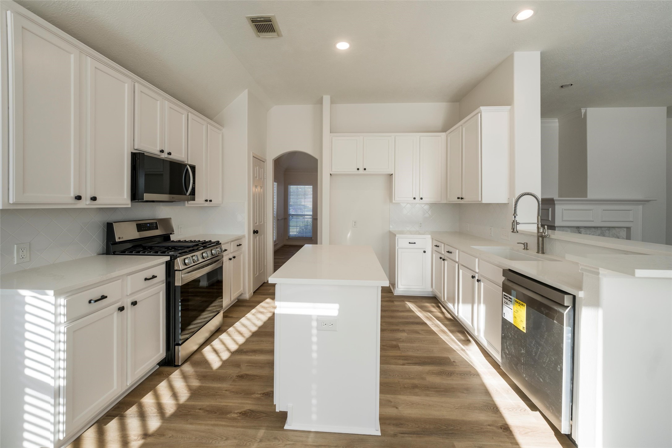 3303 Viking Landing Court Spring, TX 77388 - Photo 15 of 46 a kitchen with a sink stove and refrigerator