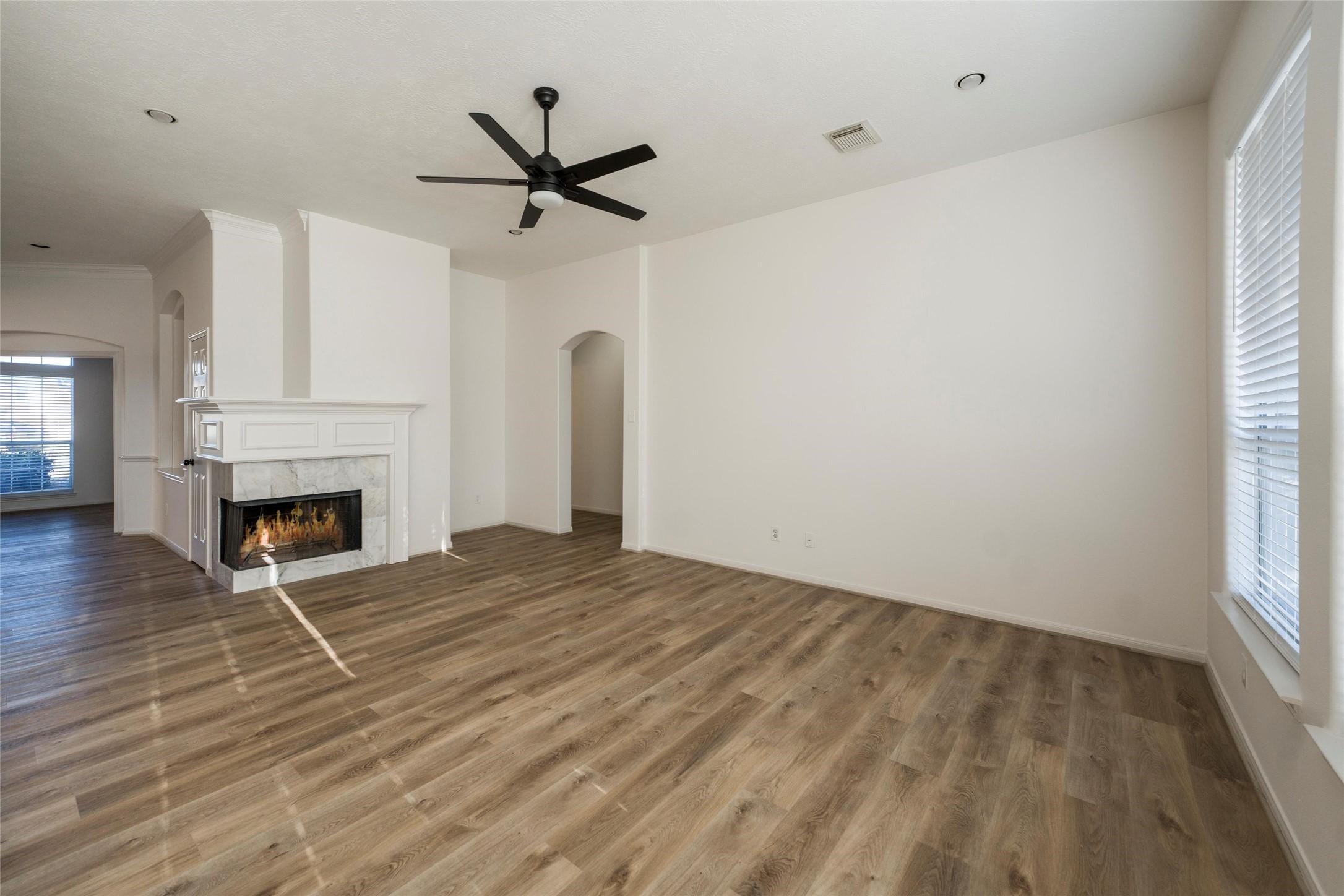 3303 Viking Landing Court Spring, TX 77388 - Photo 19 of 46 a view of empty room with fireplace and wooden floor