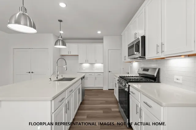 a large kitchen with kitchen island a sink stainless steel appliances and cabinets
