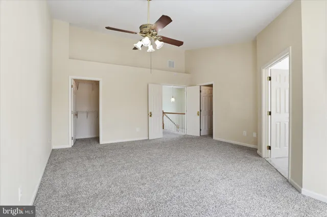 a view of a livingroom with a ceiling fan and window