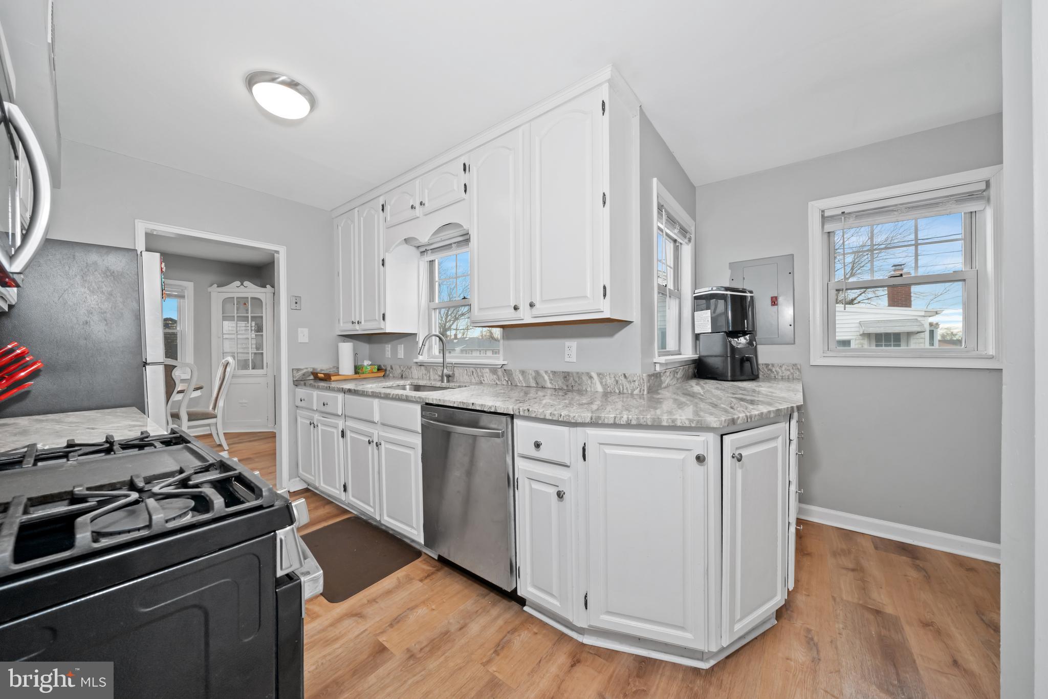 704 Harwood Road Wilmington, DE 19804 - Photo 12 of 30 a kitchen with granite countertop white cabinets and appliances