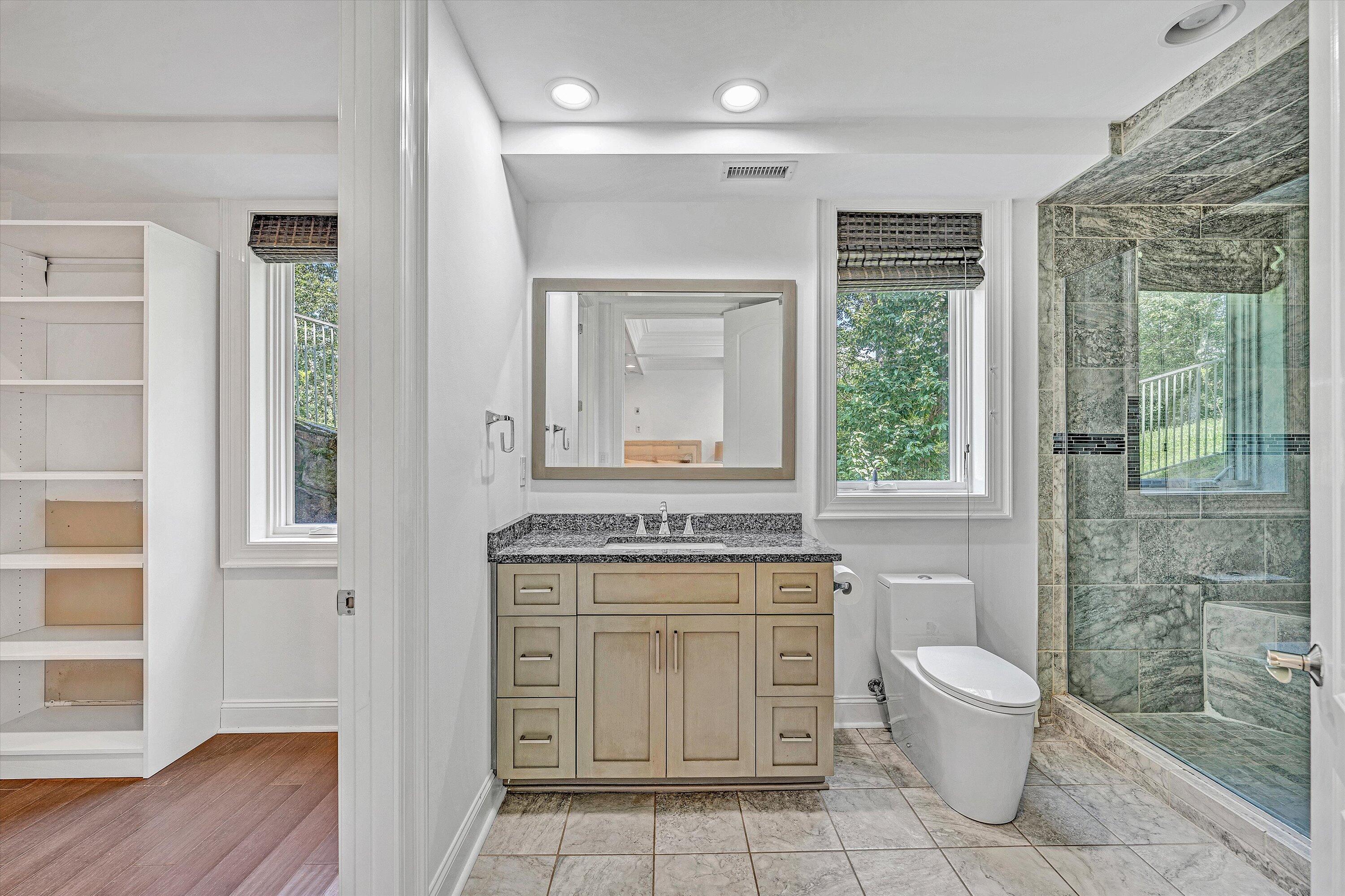 10947 Bottom Creek Road Bent Mountain, VA 24059 - Photo 37 of 59 a bathroom with a toilet sink and mirror
