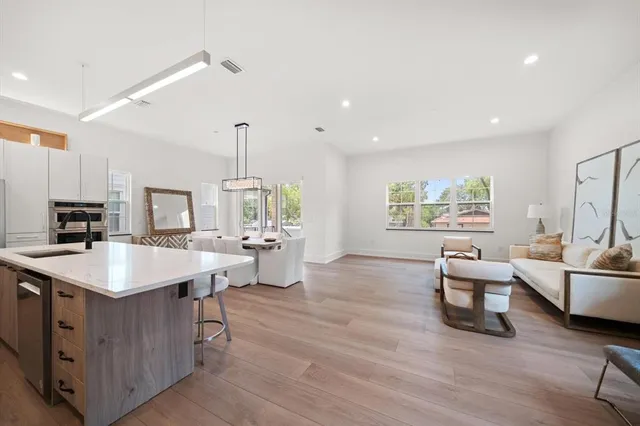 a room with furniture a large window and a chandelier