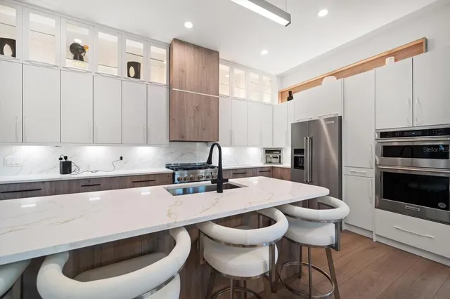 a kitchen with stainless steel appliances a sink and a refrigerator
