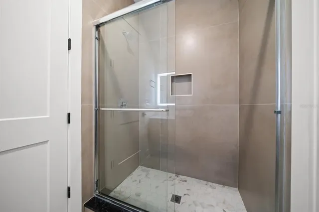 a bathroom with a shower and a sink