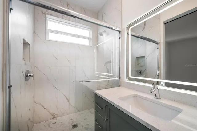 a bathroom with a sink and a mirror