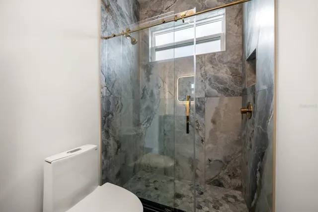 a bathroom with a shower and toilet