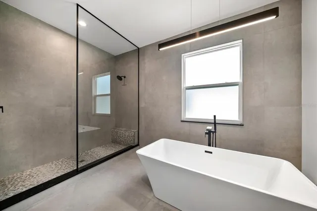 a bathroom with a bathtub and shower