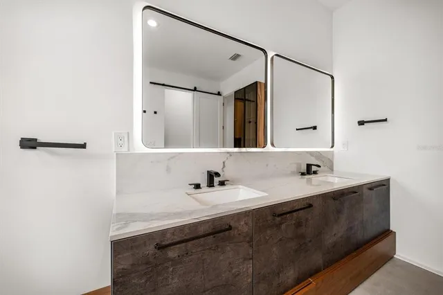 a bathroom with a double vanity sink and mirror