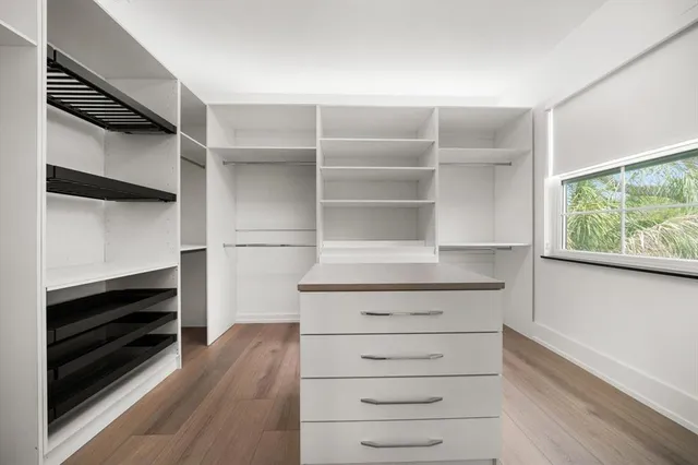 a view of walk in closet with empty racks