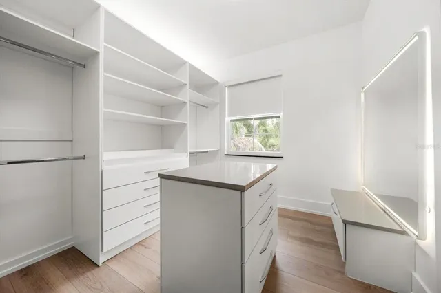 a kitchen with stainless steel appliances cabinets and wooden floor