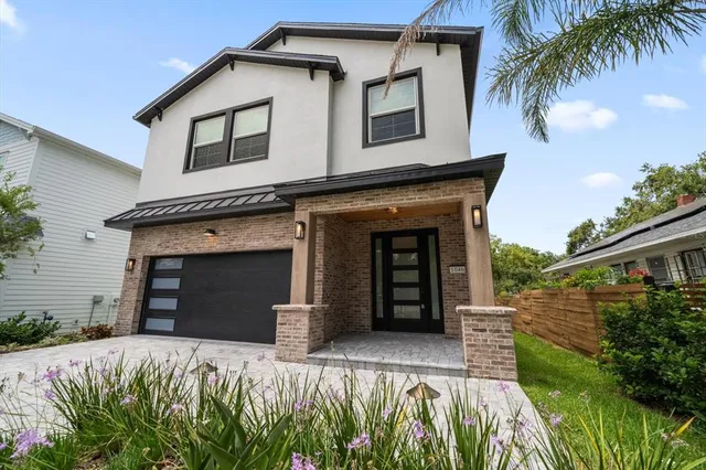 a front view of a house with a garden