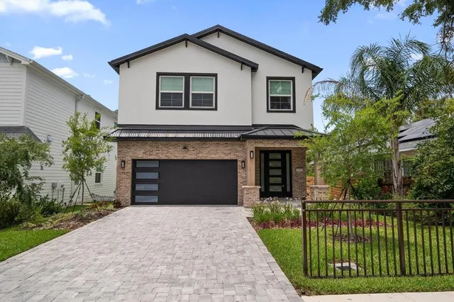 a front view of a house with a garden and plants