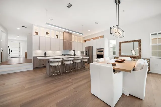 a large kitchen with a table and chairs