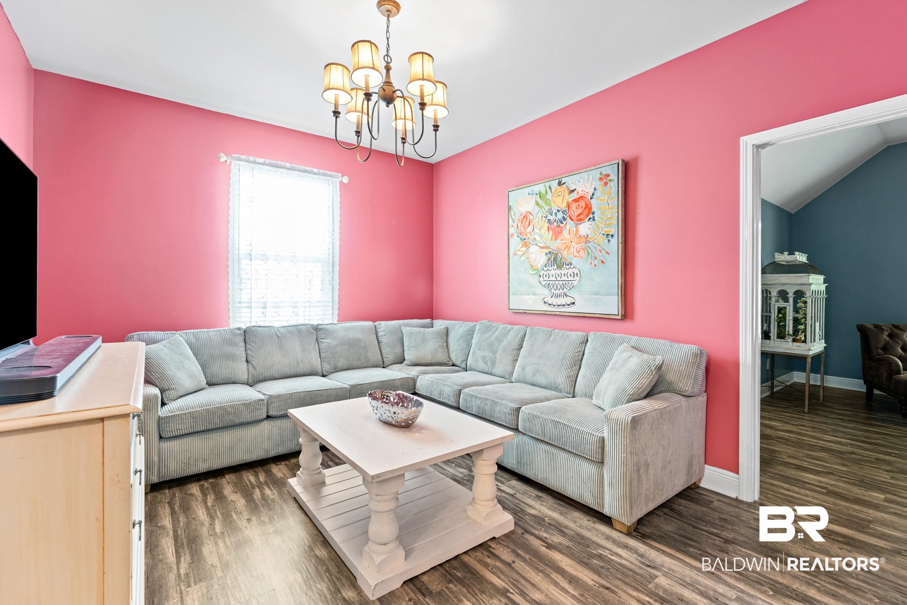 1113 Yellow Daisy Lane Foley, AL 36535 - Photo 22 of 35 Living area with a chandelier and wood finished floors