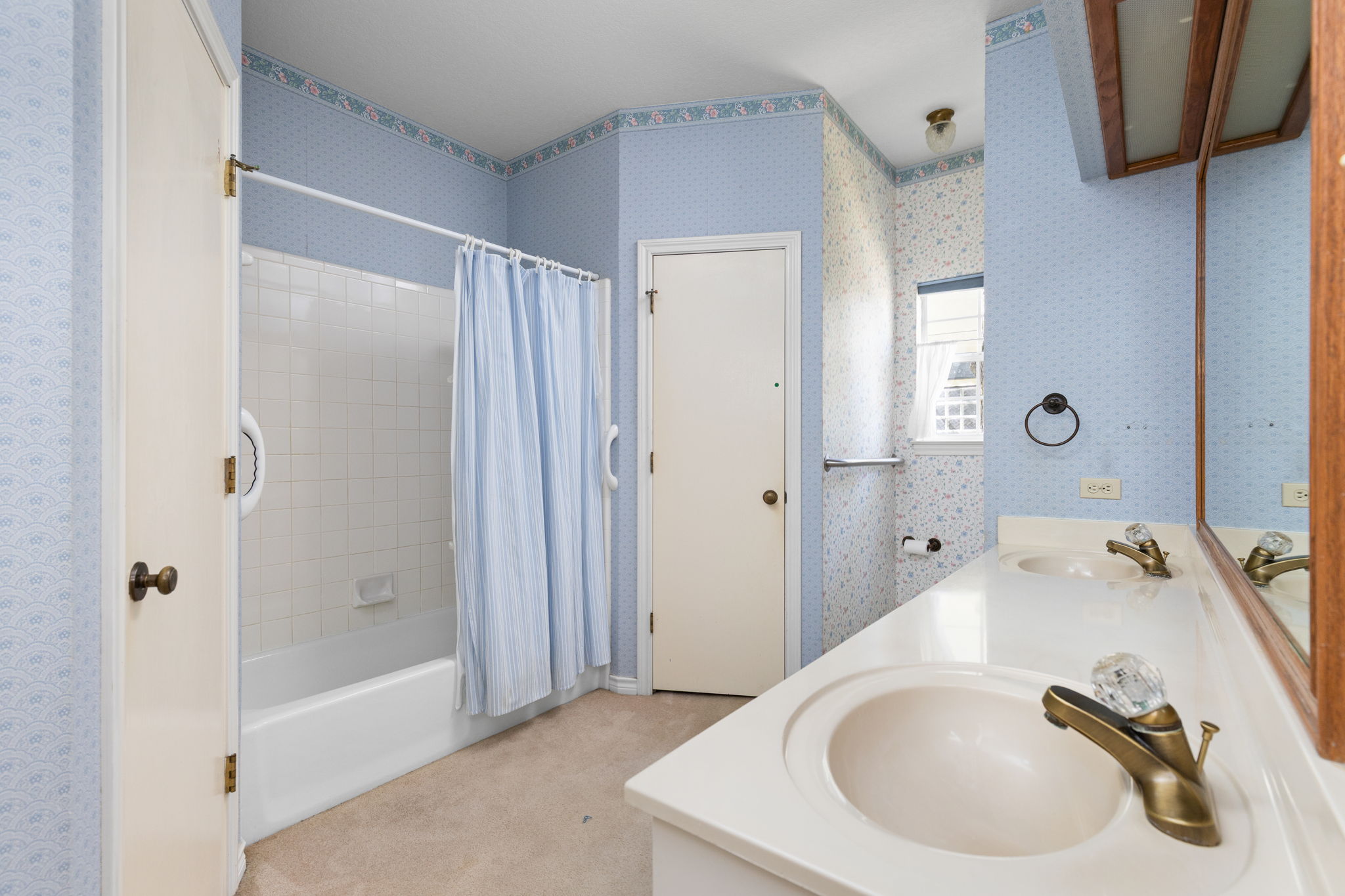 134 Canyon Road Georgetown, TX 78628 - Photo 17 of 40 A spacious bathroom layout includes a double vanity alongside a classic tub shower combination.