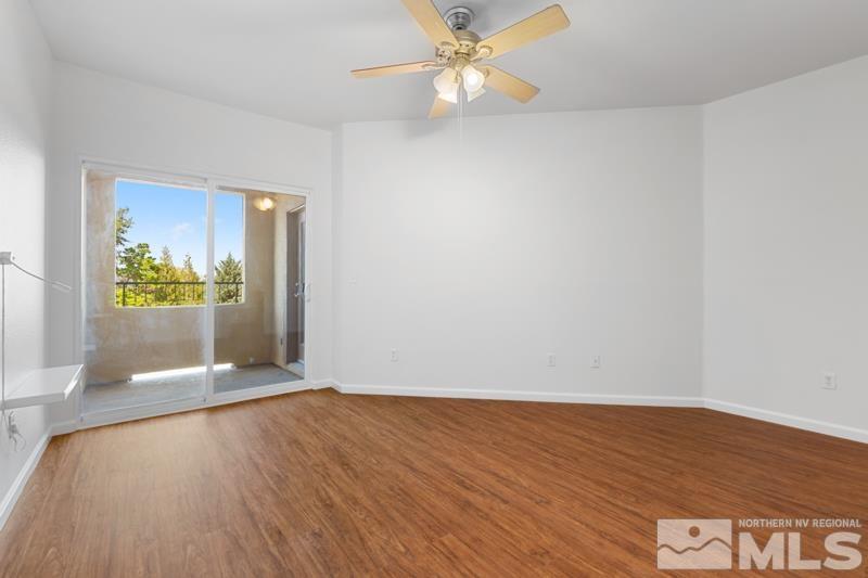 17000 Wedge Parkway, Unit 2925 Reno, NV 89511 - Photo 13 of 23 an empty room with wooden floor and windows