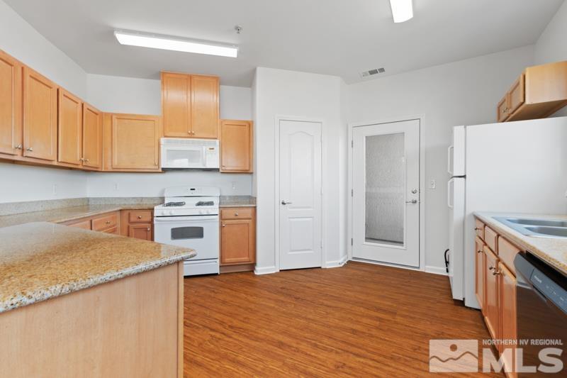 17000 Wedge Parkway, Unit 2925 Reno, NV 89511 - Photo 7 of 23 a kitchen with a stove a sink and a refrigerator