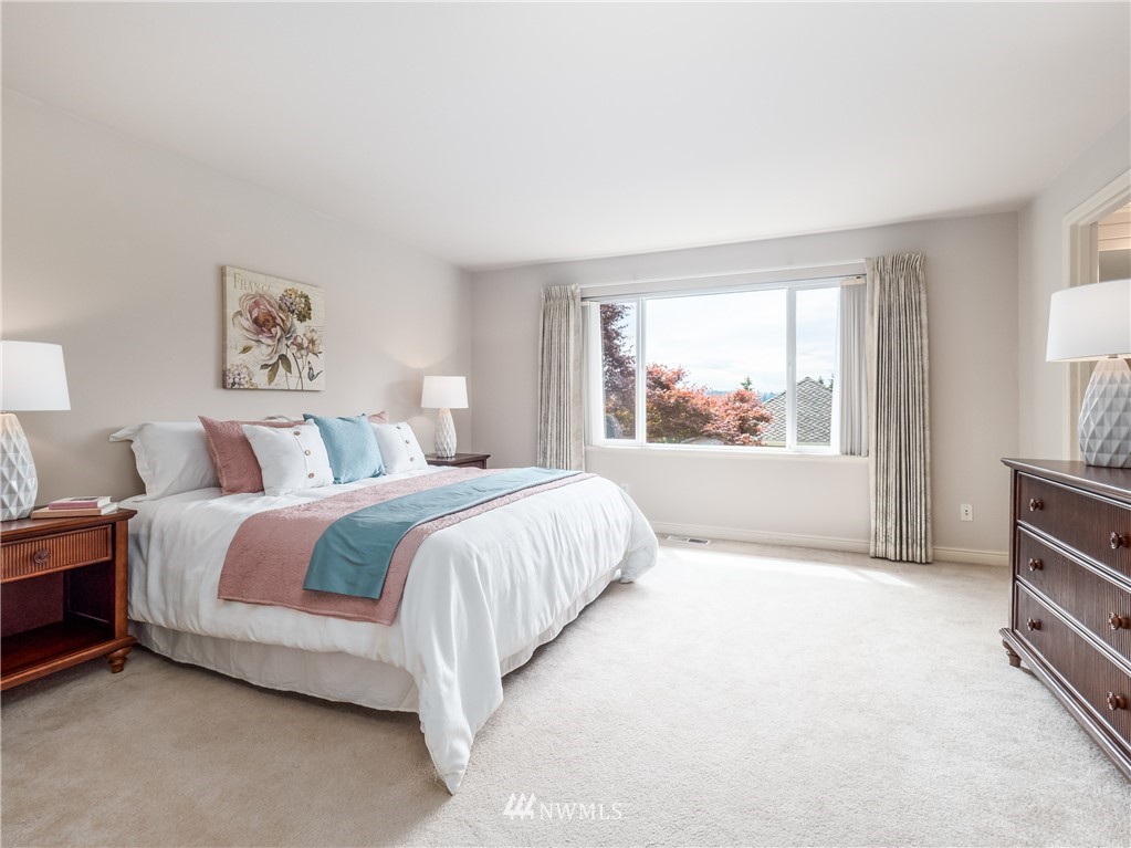 20104 27th Avenue Southeast Bothell, WA 98012 - Photo 14 of 27 a spacious bedroom with a bed and a large window