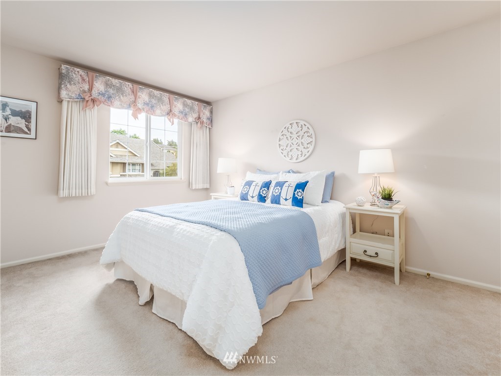 20104 27th Avenue Southeast Bothell, WA 98012 - Photo 18 of 27 a spacious bedroom with a bed and a window