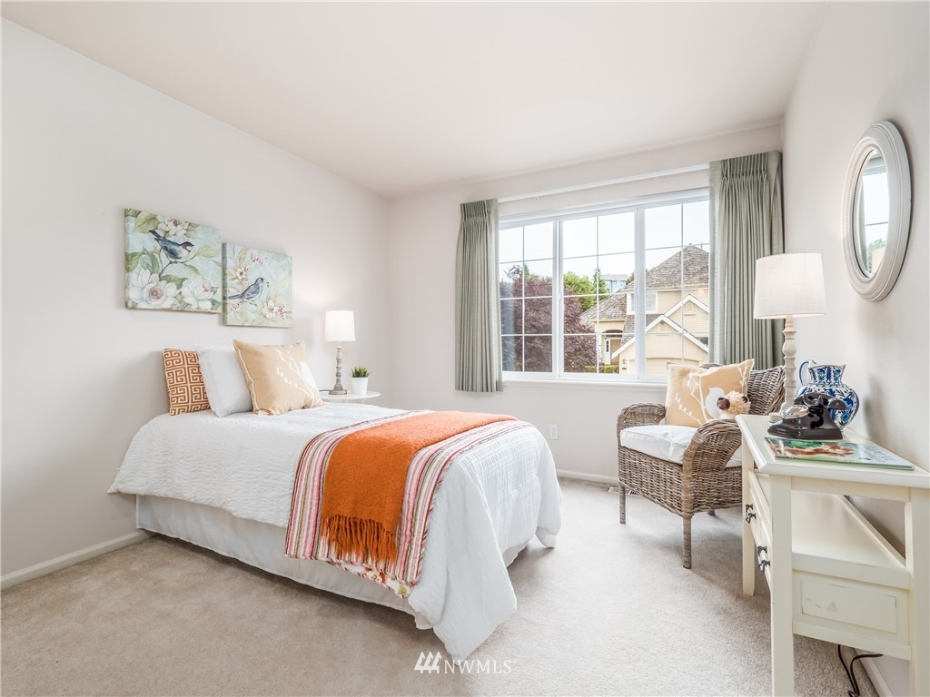 20104 27th Avenue Southeast Bothell, WA 98012 - Photo 19 of 27 a bedroom with bed a large mirror and a large window