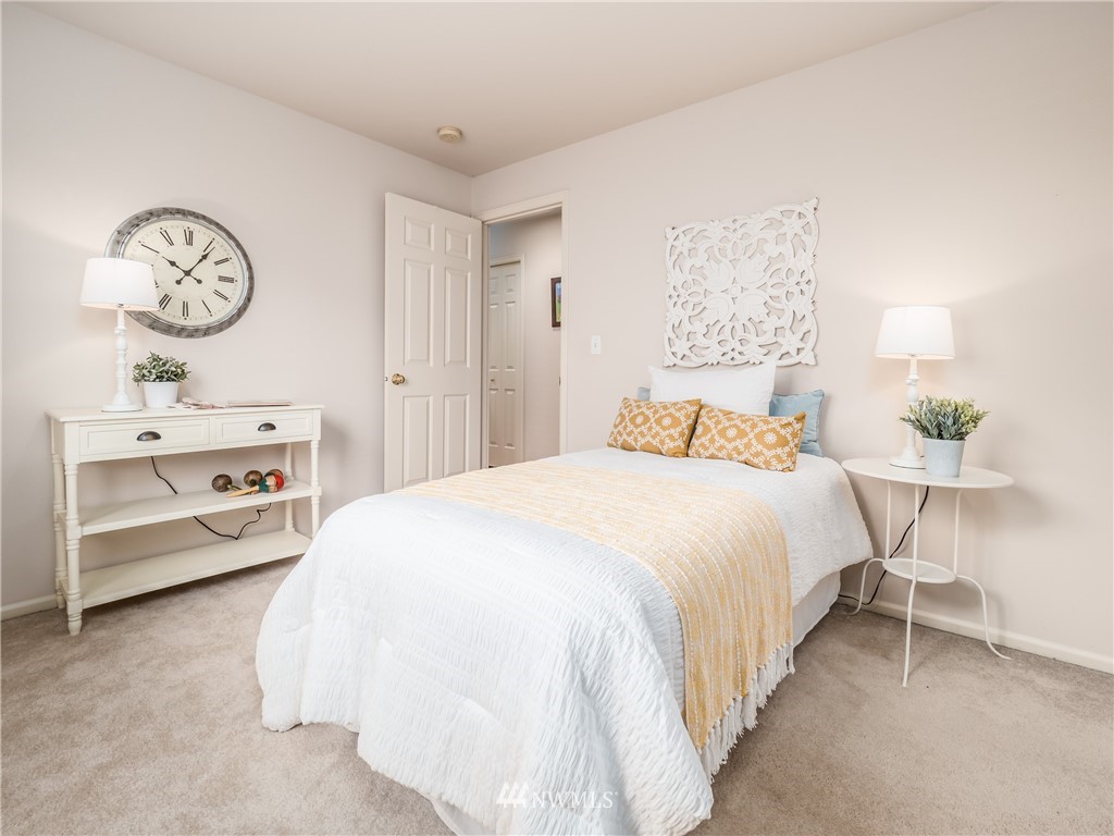 20104 27th Avenue Southeast Bothell, WA 98012 - Photo 20 of 27 a bedroom with a bed and a chandelier