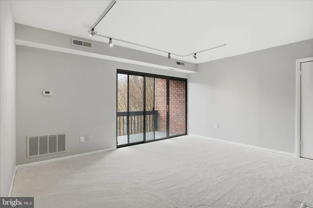 a view of a big room with windows and closet
