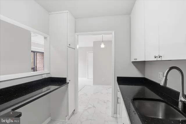a kitchen with a sink and cabinets
