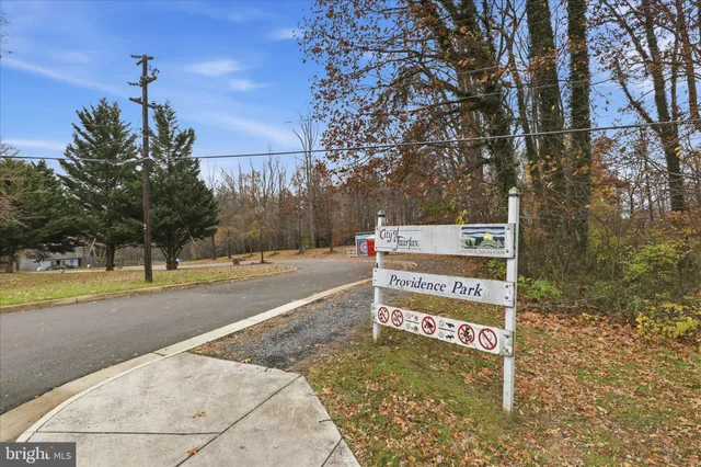 a view of patio with chairs and table under an umbrella