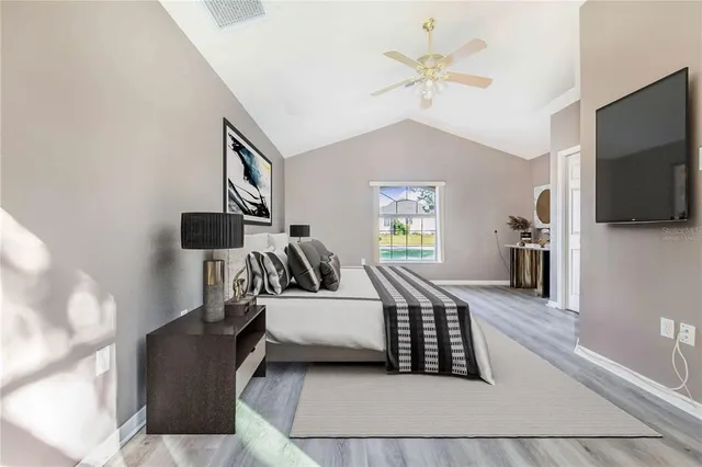 a bedroom with a bed couch and a window