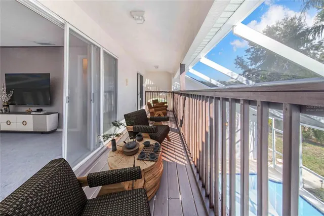 a view of a swimming pool with a patio and a yard