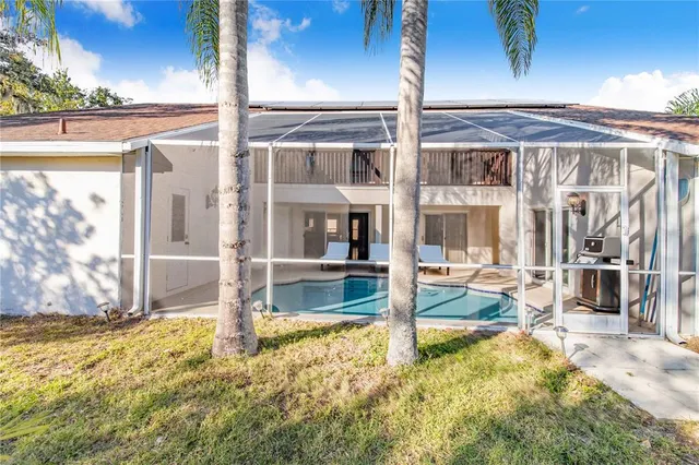 a view of a house with a yard and potted plants
