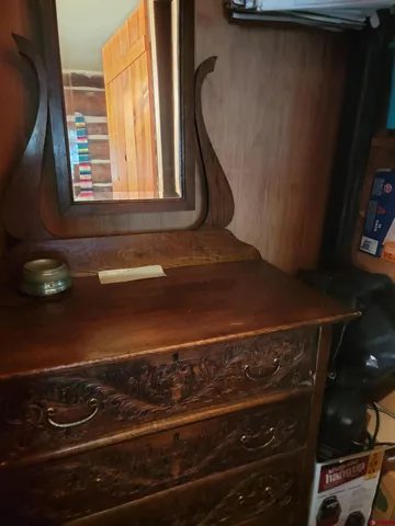 a bed sitting in a kitchen next to a window