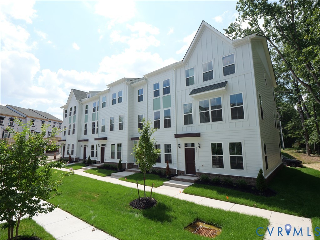 a city view with tall buildings and a yard