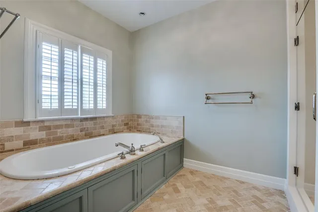 a bathroom with a bathtub and a window