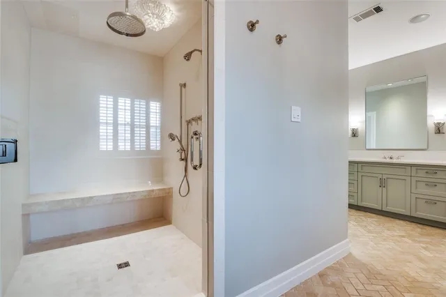 a bathroom with a tub sink and mirror