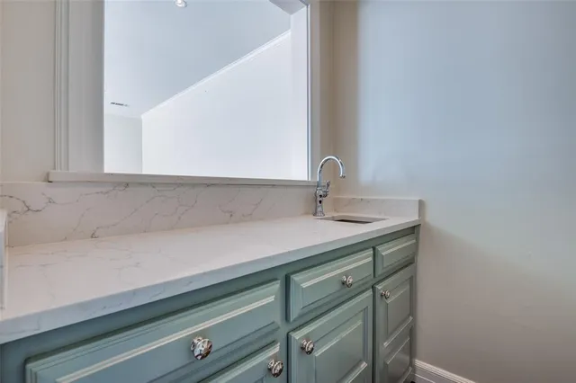 a bathroom with a sink and cabinets