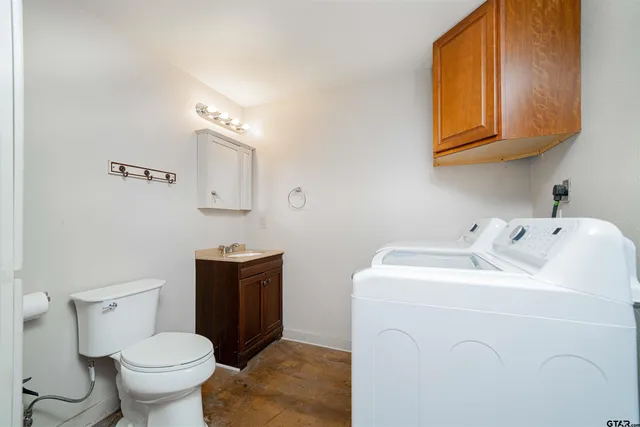 a bathroom with a toilet sink and mirror