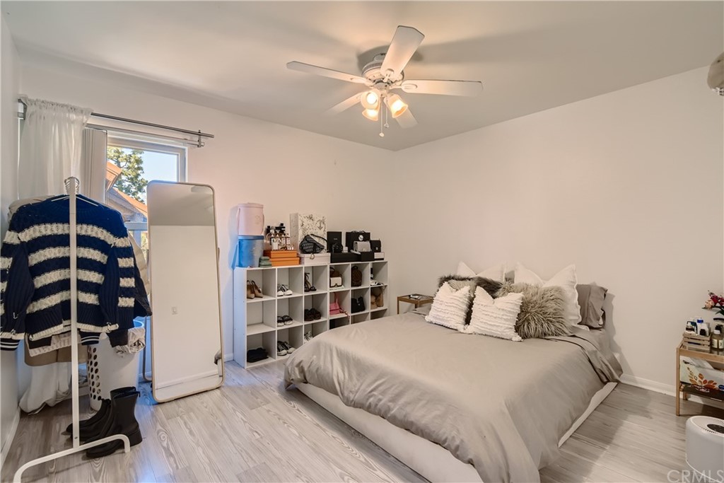 207 Orange Blossom, Unit 23 Irvine, CA 92618 - Photo 12 of 28 a bedroom with a bed and wooden floor