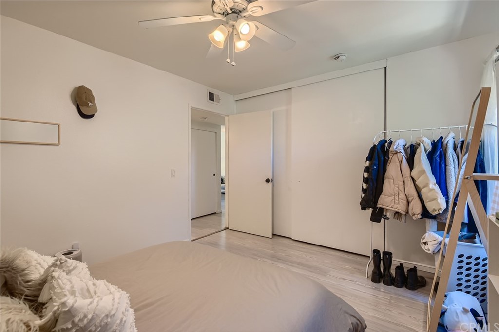 207 Orange Blossom, Unit 23 Irvine, CA 92618 - Photo 14 of 28 a view of walk in closet with clothes and shoes