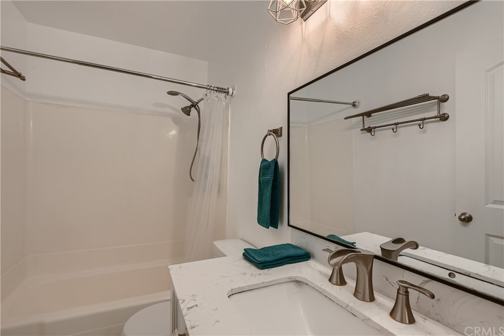 207 Orange Blossom, Unit 23 Irvine, CA 92618 - Photo 16 of 28 a bathroom with a sink and shower