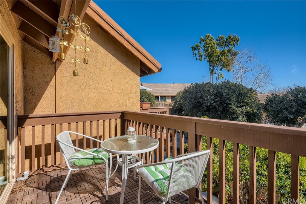 207 Orange Blossom, Unit 23 Irvine, CA 92618 - Photo 20 of 28 a view of a chair and tables in the balcony