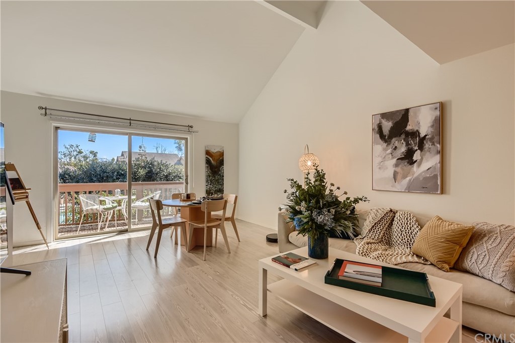 207 Orange Blossom, Unit 23 Irvine, CA 92618 - Photo 2 of 28 a living room with furniture large window and wooden floor